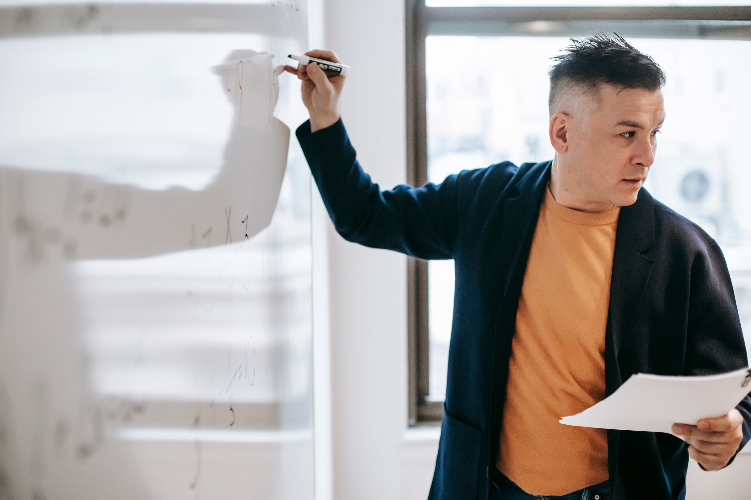 Photo Of Man Teaching On White Board